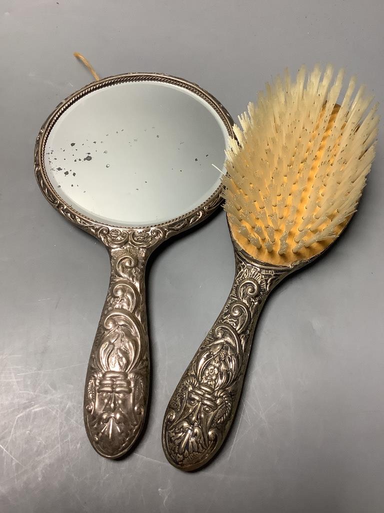 Two silver-topped narrow cylindrical toilet bottles, a silver backed-hand mirror and matching hairbrush, a comb and a silver compact